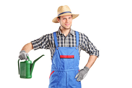 Gardener holding a watering can isolated on white backgroundの写真素材