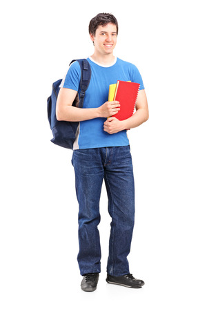 Full length portrait of a male student holding notebooks isolated on white backgroundの写真素材