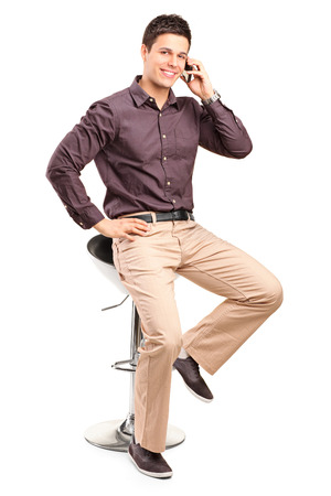 Stylish man talking on a cell phone isolated on white backgroundの写真素材