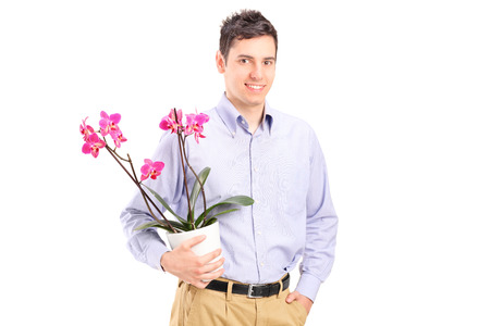 Young man holding a flowerpot isolated on white backgroundの写真素材