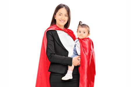 Mother and daughter in superhero costumes posing isolated on white background