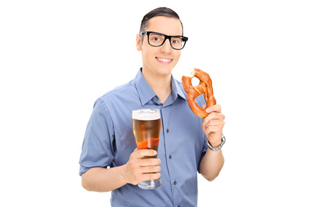 Man eating pretzel and drinking beer isolated on white backgroundの写真素材