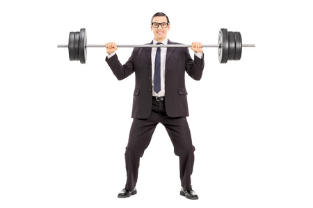 Full length portrait of a businessman holding a heavy weight isolated on white backgroundの写真素材
