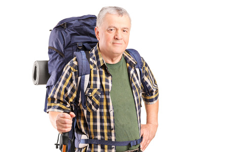 Mature mountaineer holding a hiking pole isolated on white backgroundの写真素材