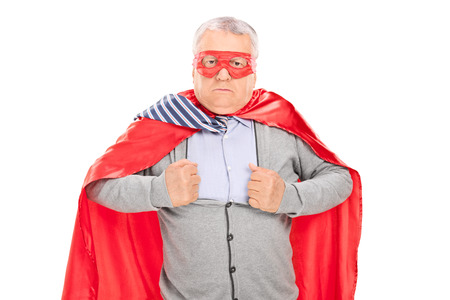 Senior in superhero costume tearing his shirt isolated on white backgroundの写真素材
