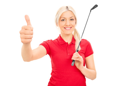 Smiling female golfer giving thumb up isolated on white backgroundの写真素材