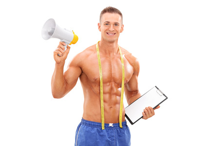 Young fitness coach holding a megaphone isolated on white backgroundの写真素材