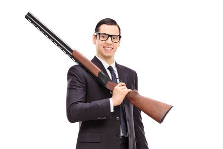 Businessman holding a rifle isolated on white background