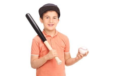 Cute little boy with a baseball cap holding a baseball bat and a ball isolated on white background