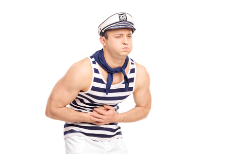 Young male sailor feeling stomach ache isolated on white backgroundの写真素材