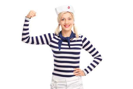 Blond female sailor showing her bicep and looking at the camera isolated on white backgroundの写真素材