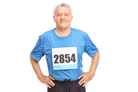 Senior man in sportswear with a race number on his chest looking at the camera isolated on white...