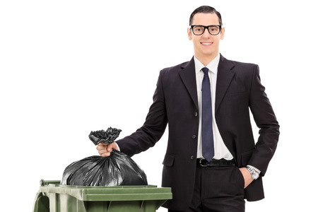 young businessman taking out the trash isolated on white backgroundの写真素材