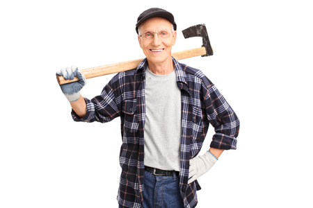 Studio shot of a cheerful senior logger holding an axe and looking at the camera isolated on white backgroundの写真素材