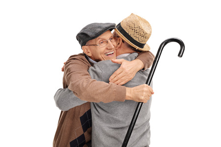 Studio shot of two old friends hugging each other isolated on white background