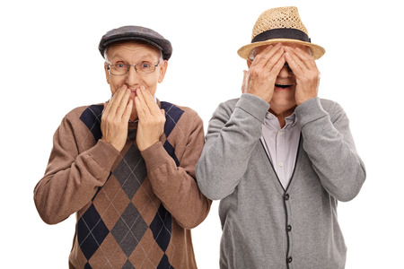 Two cheerful senior gentlemen covering their eyes and mouth isolated on white backgroundの写真素材