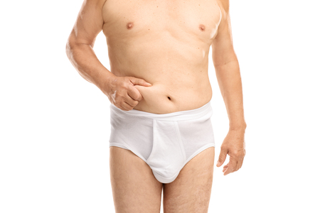 Close-up on a waist of an old man in white underwear isolated on white backgroundの写真素材