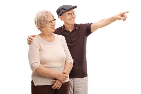 Senior man showing something to his wife isolated on white background