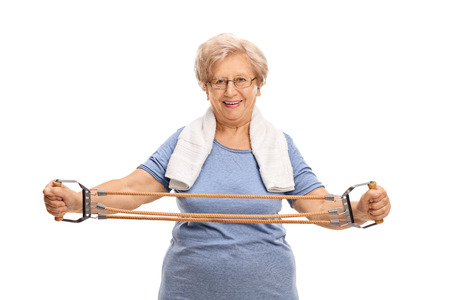 Older woman exercising with a resistance band isolated on white background