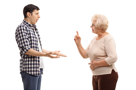 Studio shot of a young man arguing with a mature woman isolated on white backgroundの写真素材