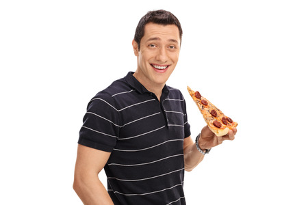 Young man having a slice of pizza isolated on white backgroundの写真素材