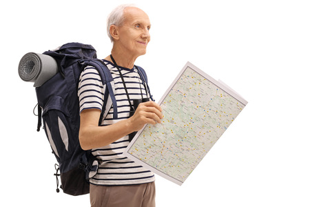 Mature male hiker holding a generic map and looking in the distance isolated on white backgroundの写真素材