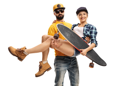 Bearded man carrying a female skater with a longboard in his hands isolated on white backgroundの写真素材