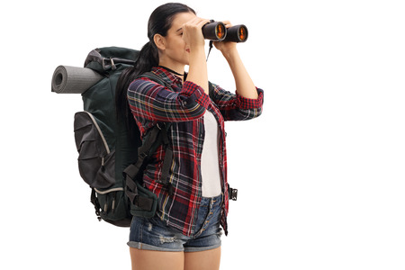 Female hiker looking through binoculars isolated on white background