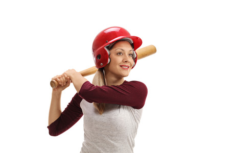 Female baseball player with a wooden bat ready to strike isolated on white background