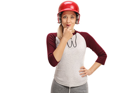 Female baseball coach blowing a whistle isolated on white background