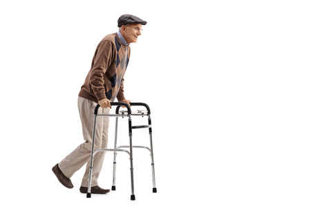 Full length portrait of a senior using a walker isolated on white backgroundの写真素材