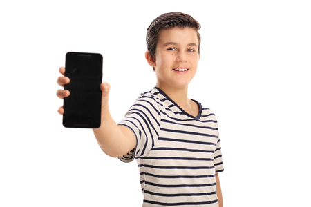 Boy showing a phone isolated on white backgroundの写真素材