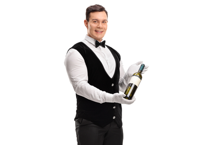 Waiter holding a bottle of wine isolated on white backgroundの写真素材