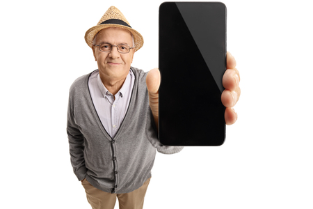 Mature man showing a phone isolated on white backgroundの写真素材