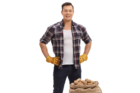 Farmer with a burlap sack filled with potatoes isolated on white backgroundの写真素材