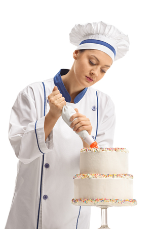 Female chef making a cake isolated on white backgroundの写真素材