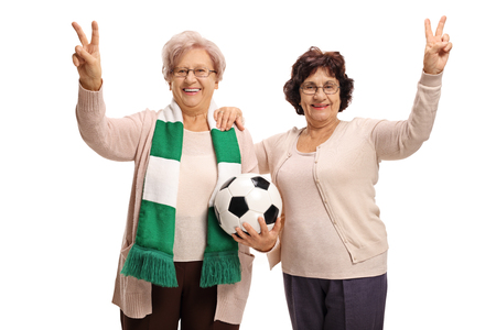 Elderly soccer fans making victory gestures isolated on white backgroundの写真素材