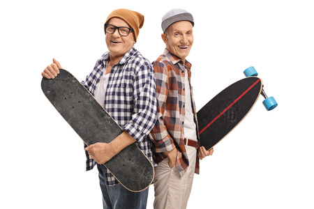 Elderly hipsters with a skateboard and a longboard looking at the camera and smiling isolated on white backgroundの写真素材