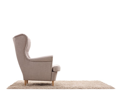 Armchair on a carpet isolated on white backgroundの写真素材