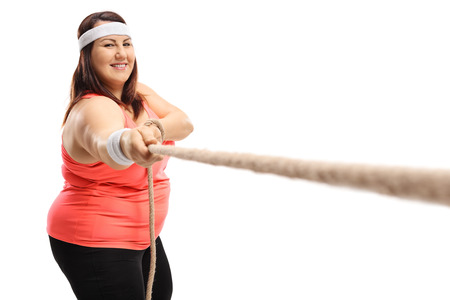 Overweight woman pulling a rope isolated on white background