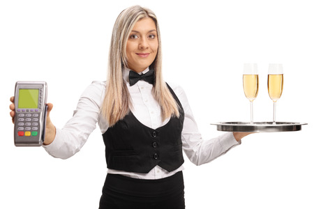 Waitress holding a payment terminal and a tray with two glasses of wine isolated on white backgroundの写真素材
