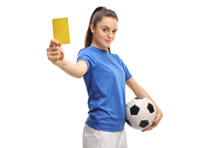 Female soccer player showing a yellow card isolated on white backgroundの写真素材