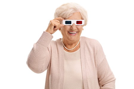 Mature woman with a pair of 3D glasses smiling isolated on white backgroundの写真素材