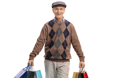 Elderly man with shopping bags isolated on white backgroundの写真素材