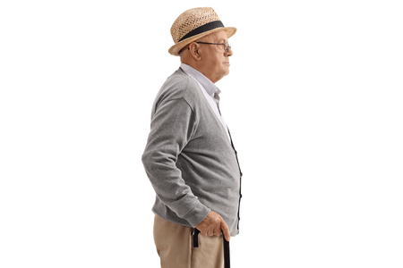 Profile shot of a senior with a cane isolated on white backgroundの写真素材