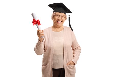 Happy mature woman with a graduation hat holding a diploma isolated on white backgroundの写真素材