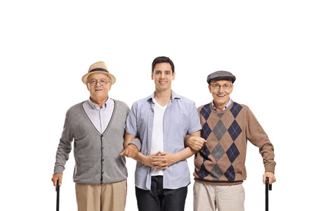 Young man posing with two elderly men with canes isolated on white backgroundの写真素材