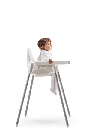 Full length profile shot of a baby sitting in a baby chair isolated on white backgroundの写真素材