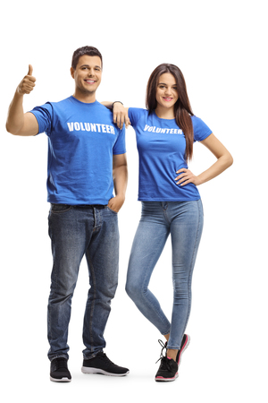 Full length portrait of young volunteers posing and showing thumbs up isolated on white backgroundの写真素材
