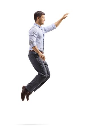 Full length profile shot of a professional young man jumping and gesturing with hand isolated on whiteの写真素材